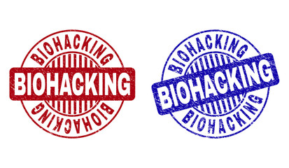 Grunge BIOHACKING round stamp seals isolated on a white background. Round seals with grunge texture in red and blue colors. Vector rubber overlay of BIOHACKING title inside circle form with stripes.