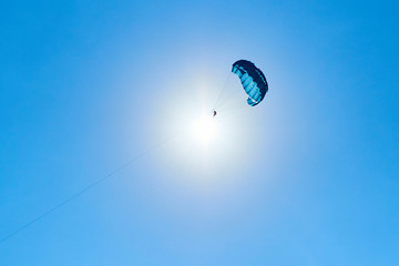 Parasailing flying against the background of the blue sky.  The concept of summer holidays, vacation.