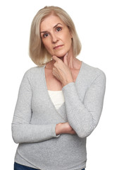 Senior woman standing on white background