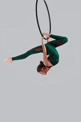 A female gymnast performing exercises on an air ring (hoop)