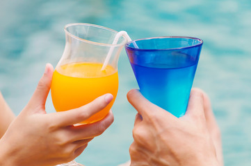 Couples enjoy with cocktail party in the swimming pool.