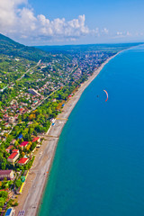 Fototapeta premium Bright beautiful view of the sea coast with rich colors of the landscape, the sea and wooded hills. Aerial view of in Abkhazia