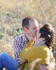 Young adult kissing love couple, have a rest outdoor, young family