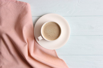 cup of coffee on wooden background top view.