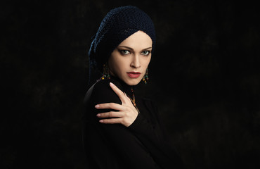 fashion studio portrait of a beautiful elegant woman wearing jewelry