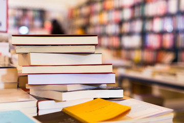 different books lying on table in library