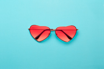 Trend photo on the theme of fashionable orange hue this season. Bright orange heart-shaped glasses...