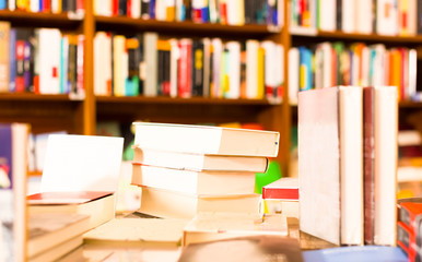 different books lying on table in library