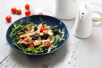 Green salad with tofu, cherry tomatoes, arugula, cucumber.
