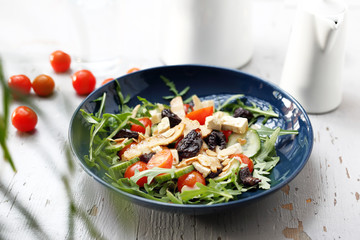 Vegetarian salad with tofu, cherry tomatoes, arugula, cucumber.