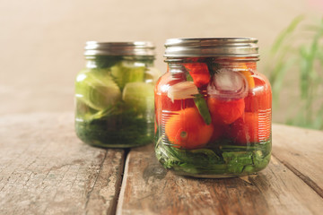 Preservation, pickles, cucumbers and tomatoes in a jar