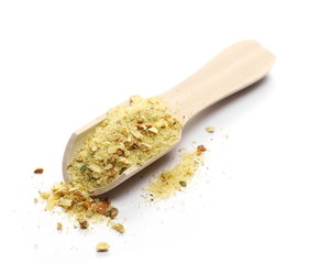 Spice mix for soups and food with wooden spoon isolated on white background