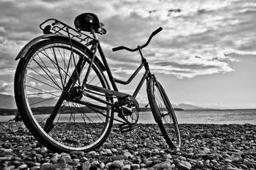 Fototapeta premium vintage bicycle by the sea. Monochrome (black and white). Tourism i in Abkhazia.