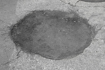 New and old asphalt surface circular patch city street pavement