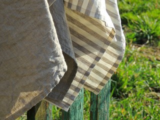 Natural linen towels on old fence