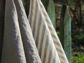 Natural linen towels on old fence