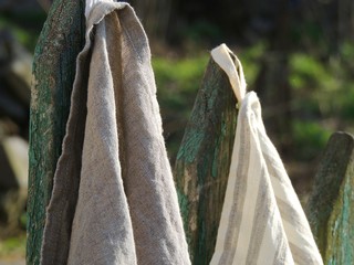 Natural linen towels on old fence