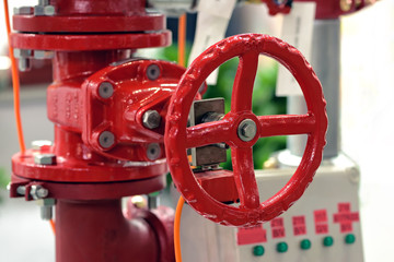 Fototapeta na wymiar Red industrial valve on pipelines system