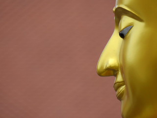 gold buddha face statue closeup