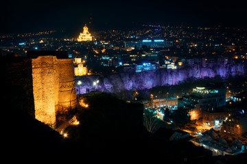 Georgia, Tbilisi - 05.02.2019. - Night view from Narikala fortress. Abanotubani, sulfur baths and holy trinity Sameba church in the background