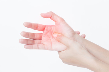 Closeup view of a woman massaging her painful hand isolated on a white background. Hands of asian young girl have inflammation