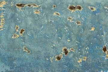 texture of blue wall with yellow spots of paint and rust