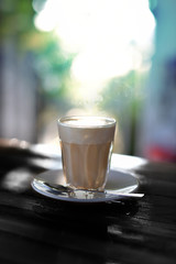 Latte coffee in glass ancient one bokeh background.