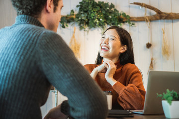 Asian woman discuss with customer in restaurant