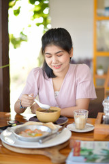 Portrait of woman eating breakfast.