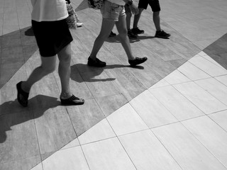 black and white people walk on street floor