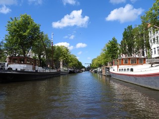 Fototapeta na wymiar Canal in Amsterdam Netherlands houses the Amstel river landmark old European city summer landscape.