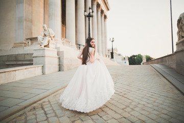 Portrait of stunning bride with long hair posing with great bouquet