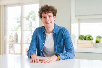 Young handsome man wearing casual denim jacket at home with a happy and cool smile on face. Lucky person.