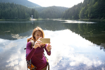 tourist girl on a mountain lake