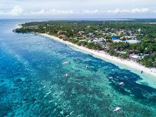 Aerial Drone Panorama Picture of the white sand Alona Beach in Panglao, Bohol in the Philippines