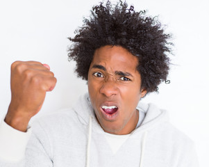 African American man over white isolated background annoyed and frustrated shouting with anger, crazy and yelling with raised hand, anger concept