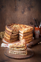 Various Traditional Ossetian meat pies with beef, chicken and salmon on a wooden background