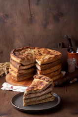 Various Traditional Ossetian meat pies with beef, chicken and salmon on a wooden background