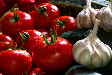 Ripe fresh harvested vegetables on table. Onions, tomatoes, garlic, pepper, zucchini in kitchen. Making delicious vegetarian meal or canning veggies for winter in jars. Concept of healthy eating