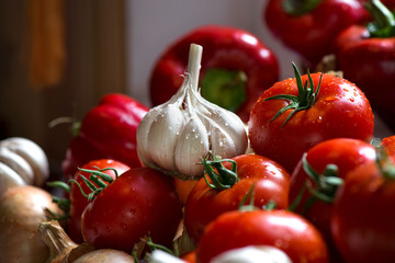 Ripe fresh harvested vegetables on table. Onions, tomatoes, garlic, pepper, zucchini in kitchen. Making delicious vegetarian meal or canning veggies for winter in jars. Concept of healthy eating