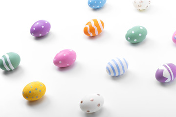 Colorful Easter eggs pattern on white wooden table background.