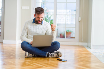 Handsome man wearing working using computer laptop annoyed and frustrated shouting with anger, crazy and yelling with raised hand, anger concept