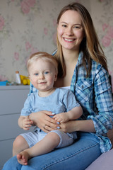 Happy young mother with baby in her arms