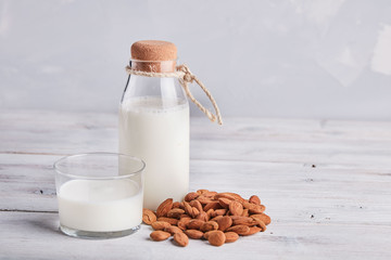 Glass of almond milk on the wooden table 
