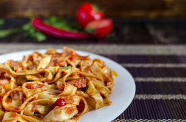 spicy spaghetti with tomato paste close-up