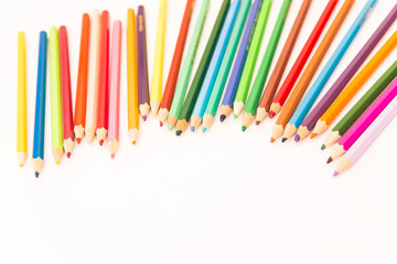 multi-colored pencils for drawing children in school and kindergartens on a white background
