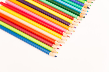multi-colored pencils for drawing children in school and kindergartens on a white background