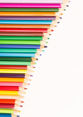 multi-colored pencils for drawing children in school and kindergartens on a white background