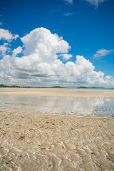 Cloudy sky reflecting on shallow waters at Sossego beach on Itamaraca island, Brazil
