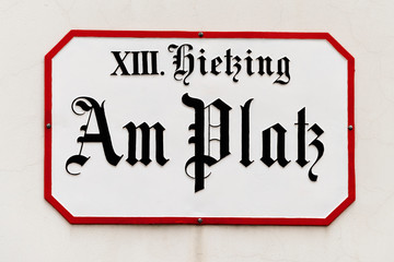 Austria, Vienna: Old vintage street sign of famous Hietzing square in retro look on house facade in...